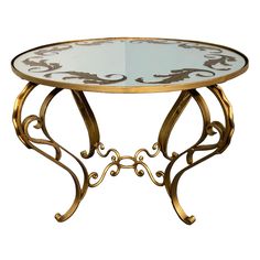 a glass and metal table with an intricate design