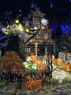 a halloween display with pumpkins and decorations