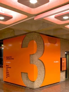 the number three is displayed on an orange wall