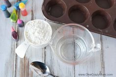 chocolate muffins and ingredients for making cupcakes on a white wooden table