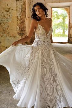 a woman in a white dress is posing for the camera