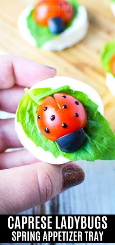 a ladybug figurine sitting on top of a green leafy plant