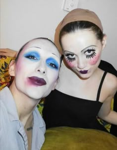 two people with painted faces posing for the camera