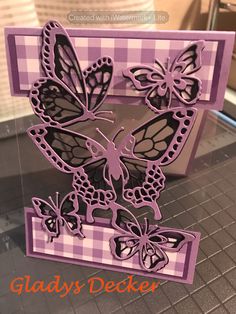 a close up of a card with butterflies on it