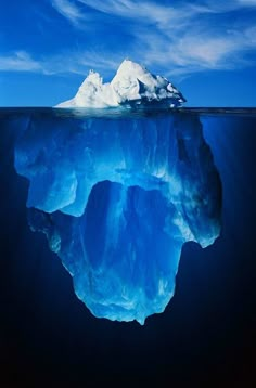 an iceberg floating in the ocean with blue water