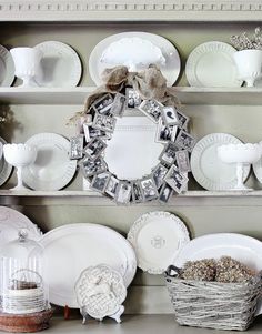 a white china cabinet filled with dishes and plates