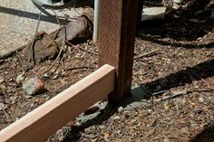 a close up of a wooden post on the ground