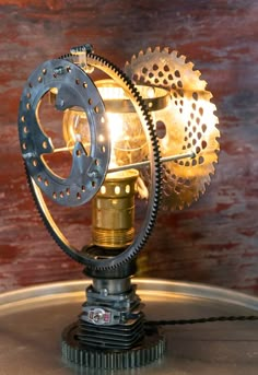 an old fashioned lamp is sitting on top of a metal tray with a wooden background