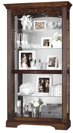 a wooden display case filled with pictures and photos