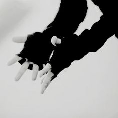 a black and white photo of two hands reaching out to touch each other's fingers