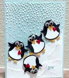 three penguins with bow ties on their heads are standing in front of a card that says joy