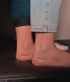 two people with small tattoos on their feet, one has the word bmeag