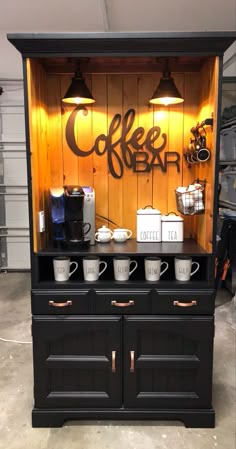 an old fashioned coffee bar with two cups on the front and one cup on the back