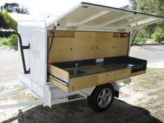 a small camper trailer with a sink on the front and back wheels is shown