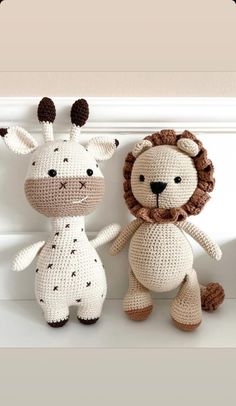 two crocheted stuffed animals sitting next to each other