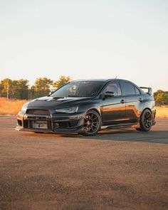 a black car is parked on the road