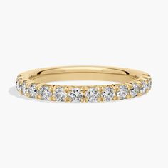 a yellow gold wedding band with five round cut diamonds on the top and bottom half