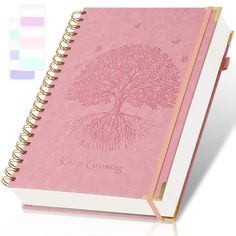 a pink notebook with a tree on it