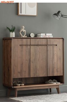 a wooden cabinet sitting next to a gray wall