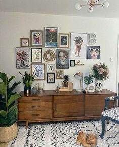 a living room filled with furniture and lots of pictures on the wall above it's coffee table