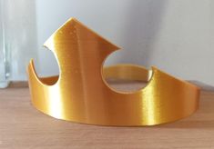 a gold crown sitting on top of a wooden table