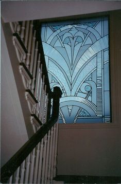 an artistic stained glass window in a stairwell