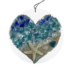 a heart shaped ornament with sea glass and starfish