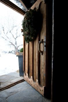 a wooden door with a wreath on it