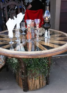 a table with wine glasses on it in front of a person sitting at a chair