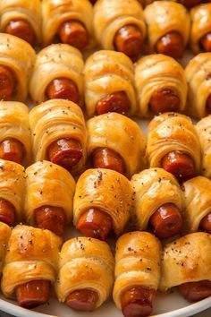 hotdogs wrapped in crescented bread on a plate