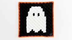 a crocheted square with a ghost on it