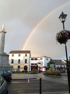 a rainbow in the sky over a city street