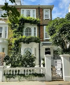 a large white house with ivy growing on it's side