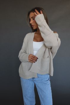 DETAILS: Our Danni Cropped Cardigan is made of a soft-to-the-to-touch thick knit material. This cardigan features a cropped boxy fit, functional pocket details, and an open bodice. The sleeves have more of a loose fit with a tight cuff to give it a trendy look. Pair this cardigan with a pair of jeans for an effortless cute look. CONTENT & CARE: 100% Acrylic SIZE & FIT: Model is 5'6" The model is wearing a size Small. Fits true to size The Fabric has stretch Tight Cardigan Outfit, Light Cardigan, Cute Cardigans, Cardigan Outfits, Thanksgiving Outfit, Cropped Cardigan, Knitting Materials, Long Hoodie, Autumn Winter Fashion