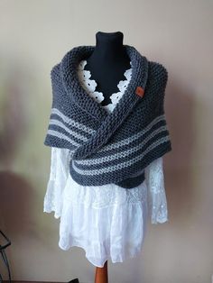 a knitted shawl draped over a mannequin