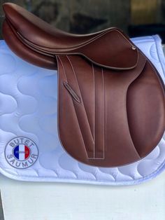 a brown and white saddle sitting on top of a table