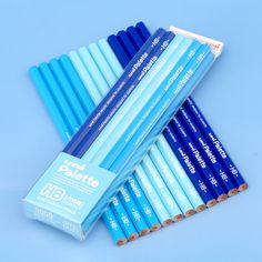 six blue pencils sitting on top of each other