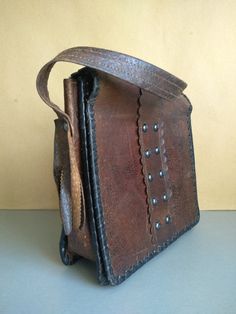 Vintage Bag Of Genuine Calfskin - Retro leather bag - Old leather bag from 60' - brown leather bag - Genuine Leather Bag - Shoulder bag The old bag has traces of use. Dimensions : The length of the handle / strap / - 58 centimeters 22 cm x 23 cm x 7 cm For other vintage bag check here : https://www.etsy.com/shop/TheVINTAGEShopBG?ref=l2-shop-info-name&section_id=22456024 FAST SHIPPING ! Possible express delivery with DHL but please first ask me for price . All pictures are real . You buy exac Brown Leather-handled Crossbody Box Bag, Distressed Brown Leather-lined Satchel Shoulder Bag, Vintage Brown Leather Tote Satchel, Everyday Vintage Brown Bags With Leather Backing, Brown Leather Saddle Shoulder Bag, Brown Leather Hobo Shoulder Bag, Vintage Brown Leather Briefcase, Rectangular, Formal Brown Saddle Bag With Leather Handles, Rectangular Textured Leather Bag