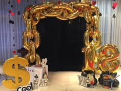 a gold balloon frame with dollar signs and other decorations