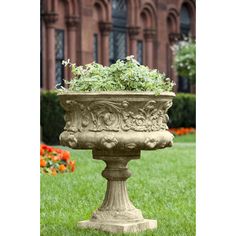 a planter filled with flowers sitting on top of a lush green field