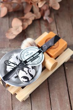 a shaving brush and soap on a wooden tray