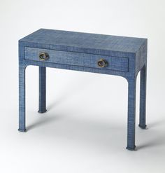 a small blue table with two drawers on one side and gold knobs on the other