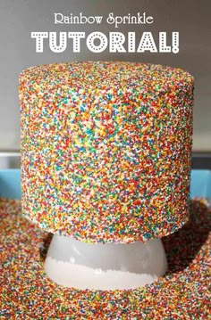 a cake with sprinkles on it sitting on top of a table