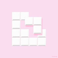 a pink background with white cubes arranged in the shape of a heart on it