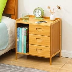 a nightstand with books and a clock on it