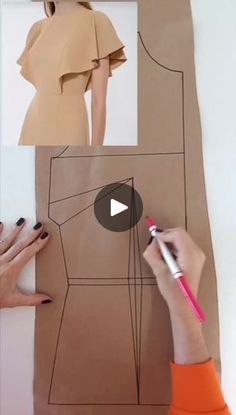 a woman is making a dress out of brown paper and some scissors on the table