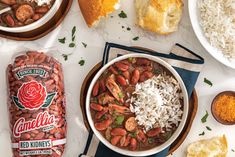 a bowl of beans, rice and bread on a table