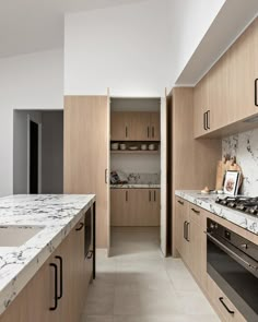 a kitchen with marble counter tops and wooden cabinets