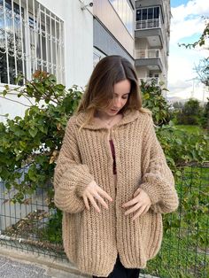 - Exquisite handmade chunky knit sweater in a soft beige hue, perfect for a cozy and stylish winter look - Crafted from premium wool for maximum warmth and comfort, designed for women - Each sweater is uniquely knit by hand, ensuring no two pieces are the same - Option for custom sizes to provide a perfect fit tailored to your measurements - Knitted with shimmery mohair yarn SIZES If you have any doubts about the size, we recommend purchasing your regular size and leaving a note to us. We promise to customize your item to your measurements! FREE SHIPPING FREE RETURNS & EXCHANGES: We will accept returns and refunds within 30 days, no questions asked! **CARE** Since Smyrna Collective products are knitted with sensitive yarns, they should be washed with cold or warm water on hand or washed in Beige Chunky Knit Sweater Coat For Cold Weather, Cozy Beige Knit Knitting Pattern, Cozy Beige Knitting Pattern, Beige Chunky Knit Cardigan For Winter, Handmade Cozy Sweater Coat For Fall, Cozy Brown Knitted Cardigan, Cozy Handmade Sweater Coat For Fall, Cozy Brown Chunky Knit Sweater Coat, Beige Knitted Cardigan For Cold Weather