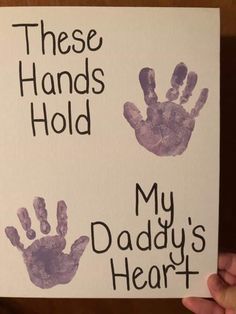 a handprinted sign that says, these hands hold my daddy's heart